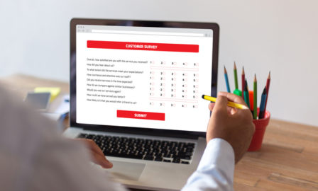 Businessman Filling Survey Form Online on Computer