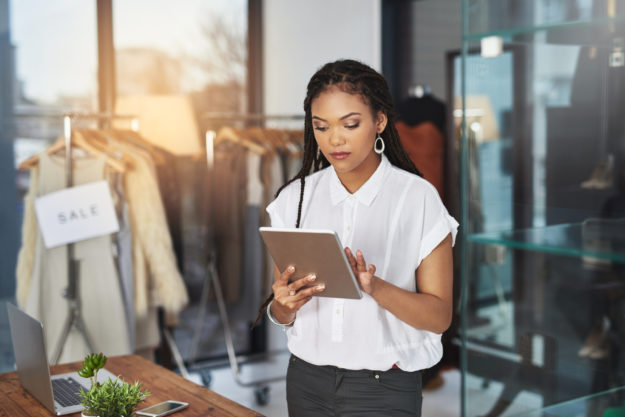 a retail professional observing notes on an ipad that stemmed from strategies around retail strategy consulting from a retail planning consultant