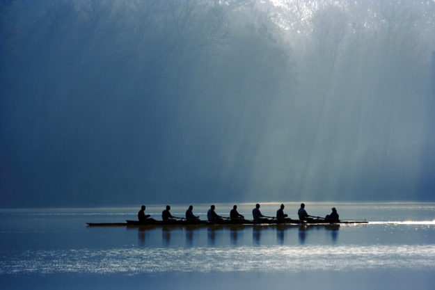 Canoe team work to symbolize organizational health and growth strategies as well as talent strategy or business transformation consultants