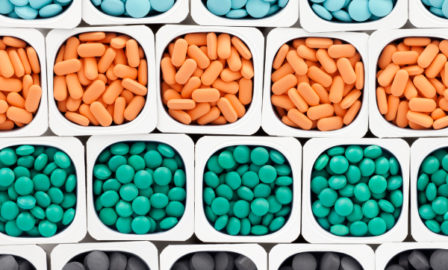 Rows of pills being prepared for use in a value-based care contract.